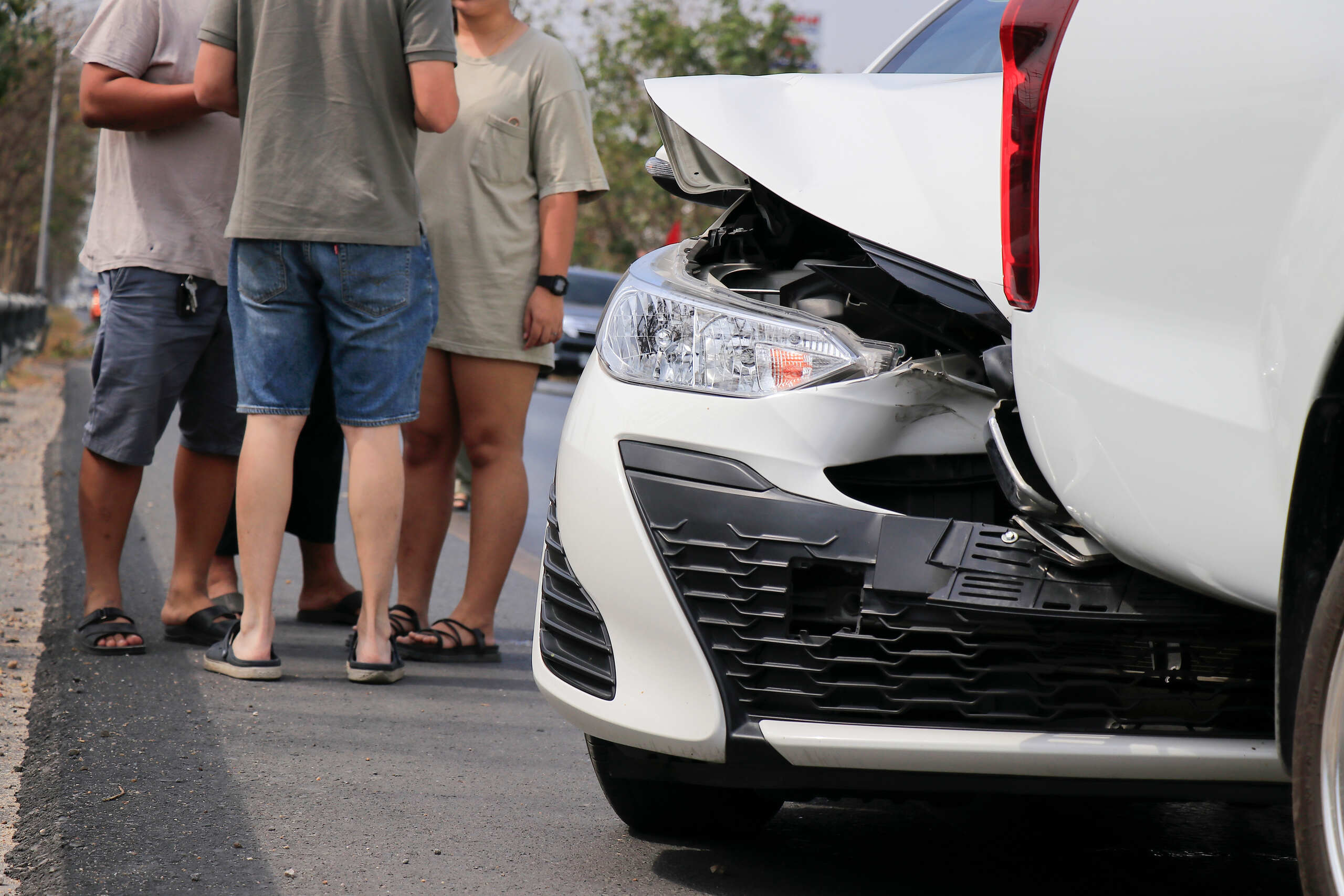 Drivers inspecting vehicle damage after a rear-end crash in Florida where fault and liability may be disputed under state accident laws